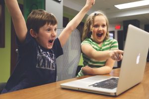 Children laughing in from of the computer