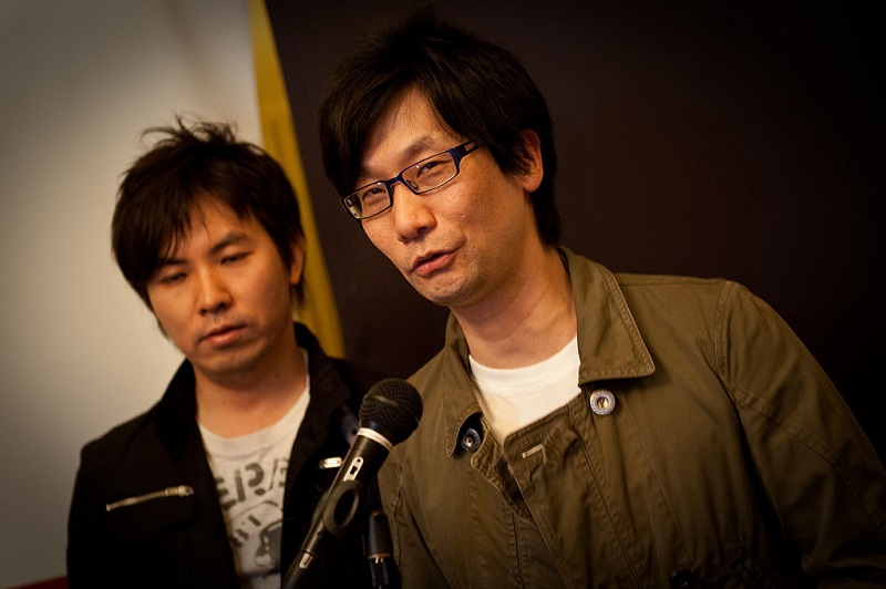 Two men standing in front of a microphone